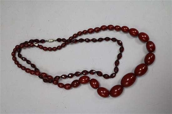 Two sets of red simulated amber beads.